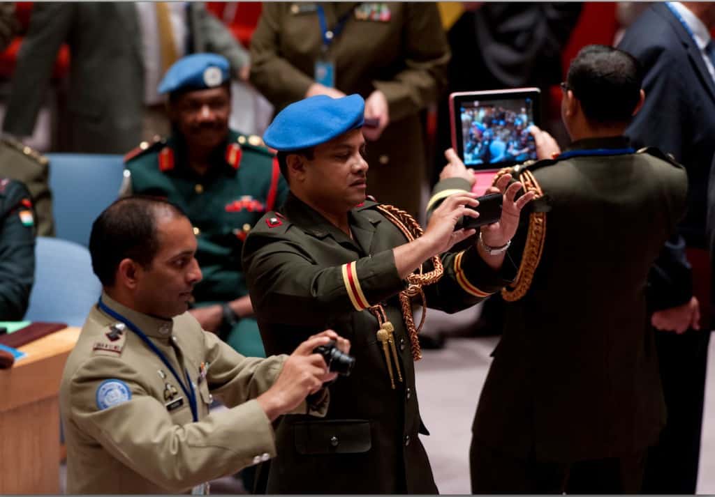 The Security Council received briefings from senior UN military officials, including the Military Advisor for Peacekeeping Operations and the Force Commanders of three UN peacekeeping missions. UN military officers attending the meeting take pictures in the Council Chamber. 09 October 2014